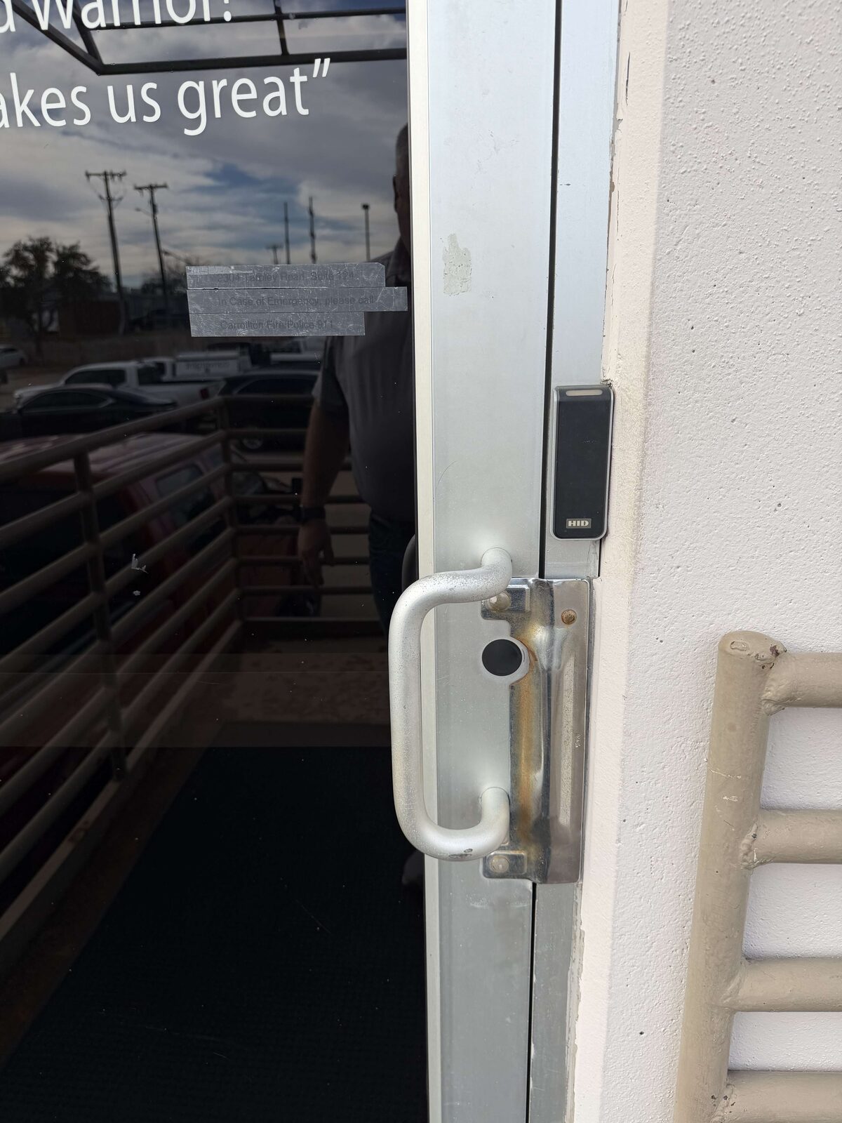Access control card reader mounted on a storefront entrance door frame