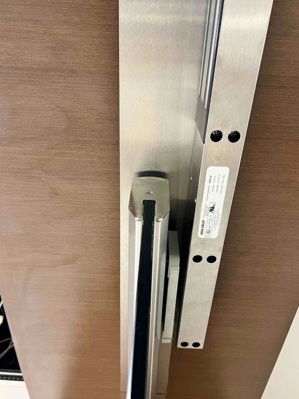 Magnetic lock system installed on a commercial glass entry door