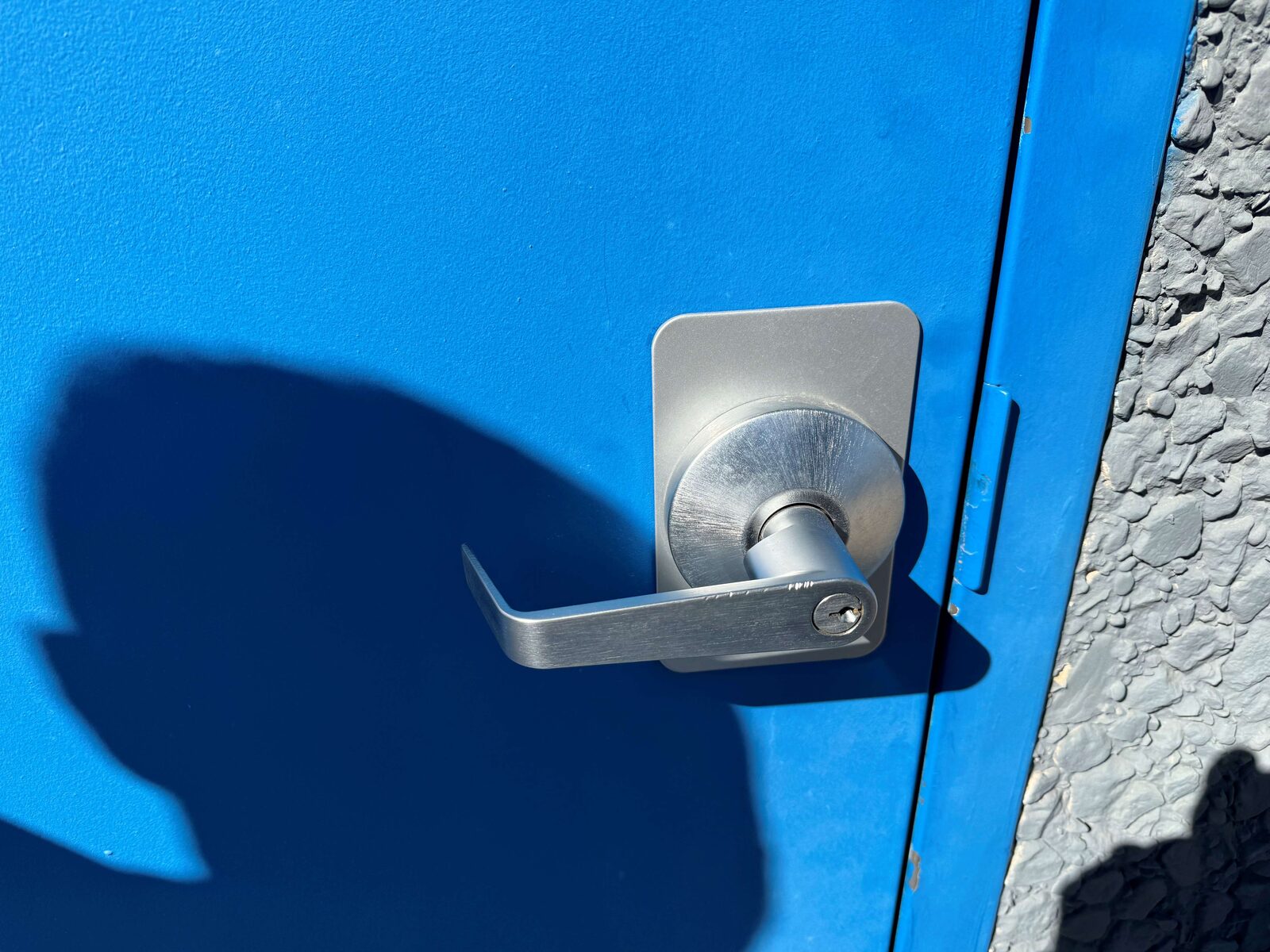 Keyed lever handle installed on an exterior commercial door