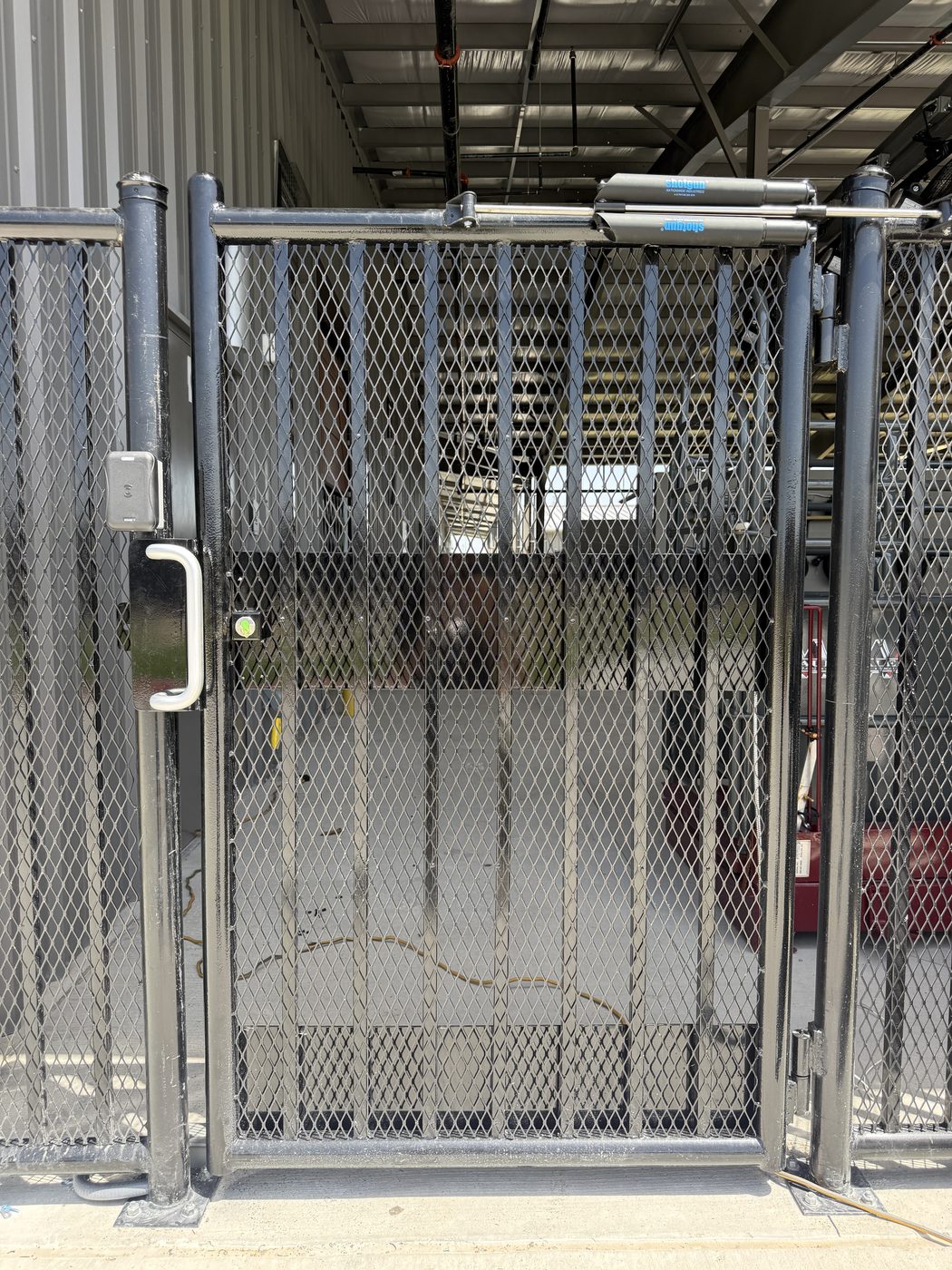 Exterior perimeter security fence with an electronic gate locking system