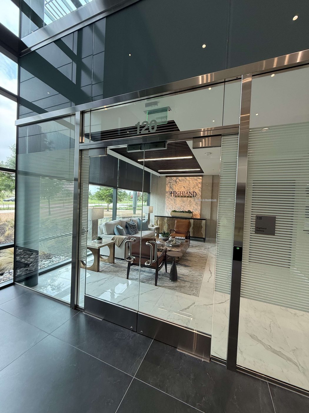 Specialty locking hardware installed on a frameless glass Herculite entrance door
