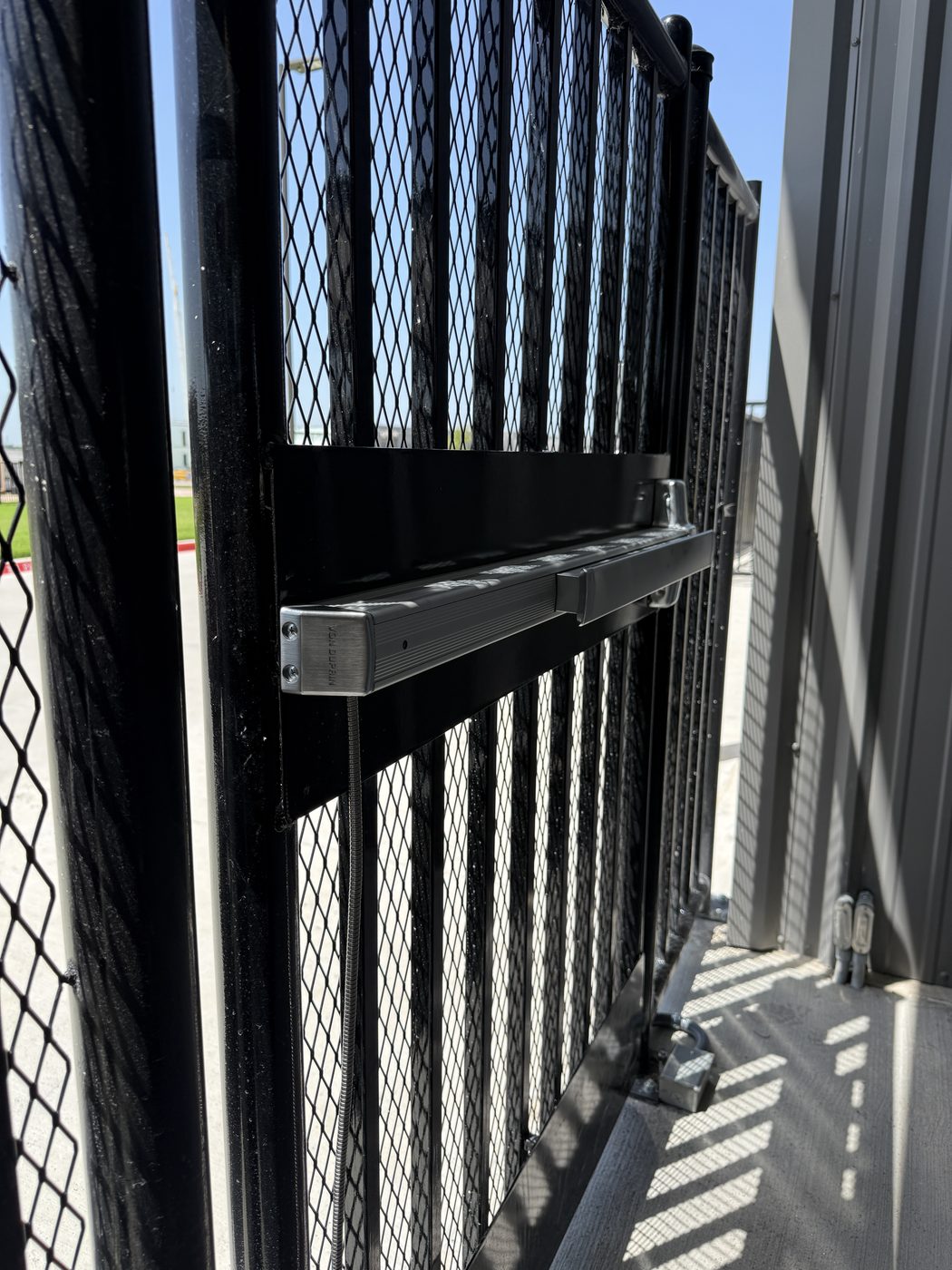Von Duprin panic exit hardware mounted on an exterior security gate