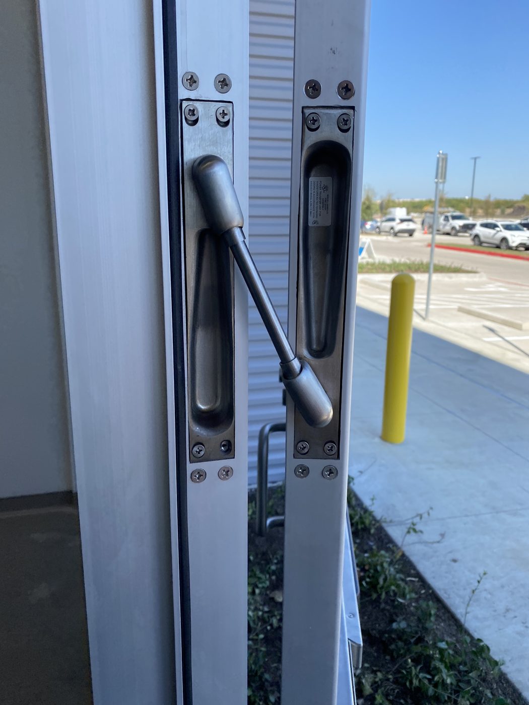 Von Duprin power transfer unit installed on an exterior commercial door assembly